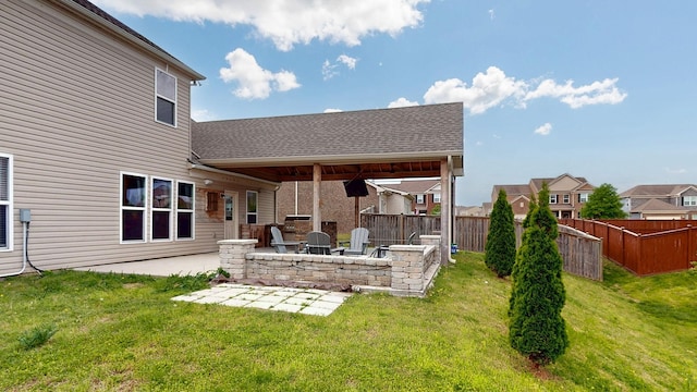 rear view of property with a yard, a shingled roof, a fenced backyard, and a patio area