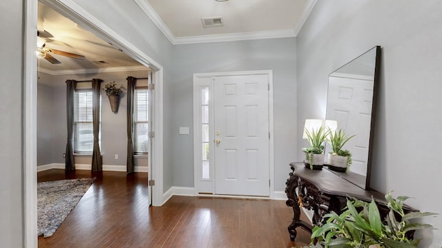 entrance foyer with a ceiling fan, baseboards, ornamental molding, visible vents, and wood finished floors