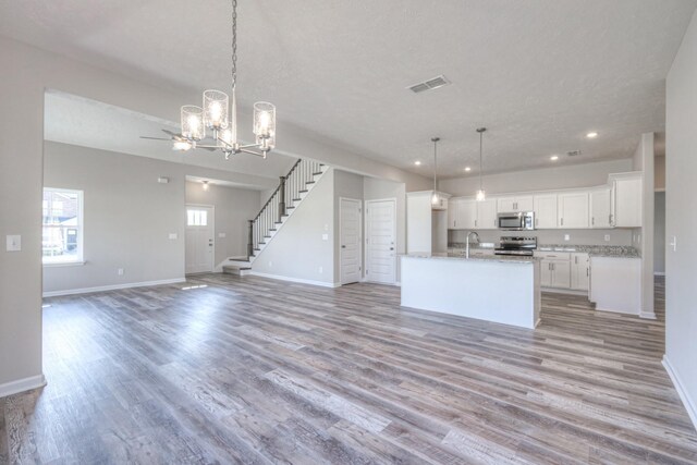 kitchen featuring visible vents, open floor plan, recessed lighting, light wood-type flooring, and appliances with stainless steel finishes