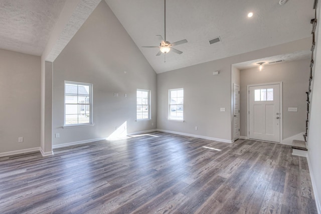 unfurnished living room featuring visible vents, wood finished floors, ceiling fan, high vaulted ceiling, and stairway