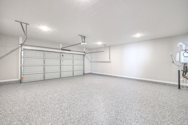 garage with baseboards and a garage door opener