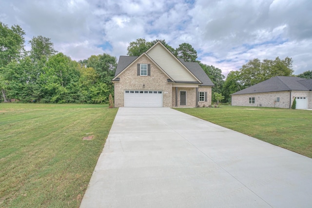 view of front of home featuring brick siding, driveway, a front yard, and a garage