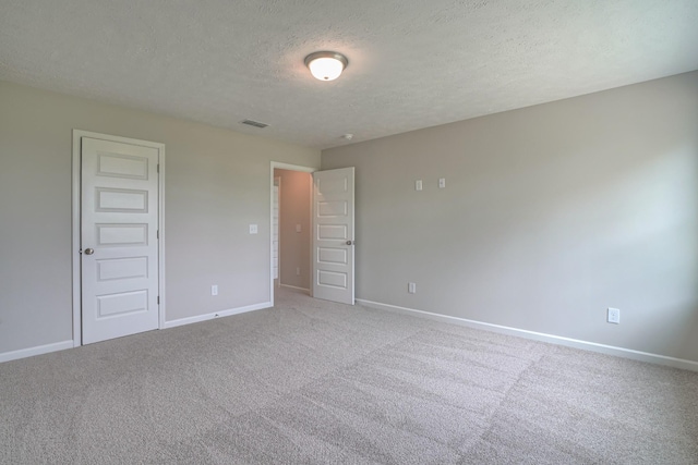 unfurnished bedroom with baseboards, carpet, and a textured ceiling