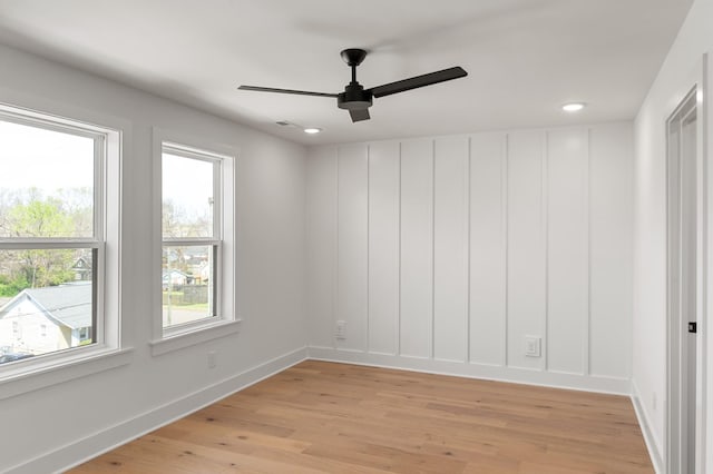 spare room featuring baseboards, recessed lighting, ceiling fan, and light wood-style flooring