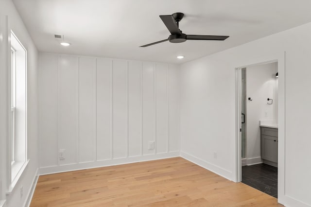 spare room with a ceiling fan, visible vents, baseboards, light wood-style floors, and recessed lighting
