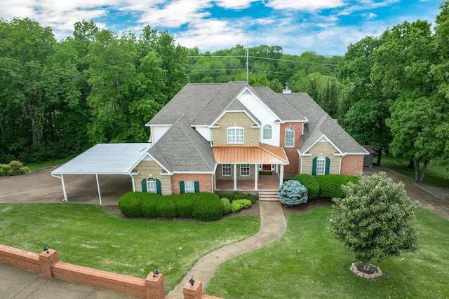 233 Timberlane Rd, Gallatin, TN 37066 - view of front of home with a shingled roof, brick siding, a carport, a front yard, and covered porch