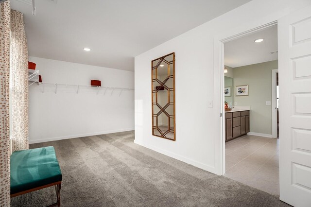 interior space with light colored carpet and light tile patterned floors