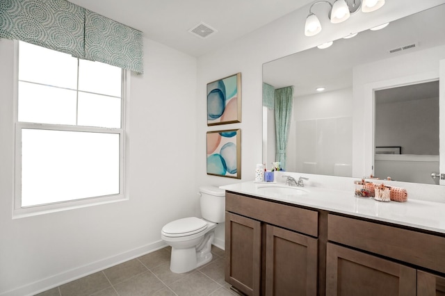 bathroom featuring baseboards, tile patterned flooring, toilet, and visible vents