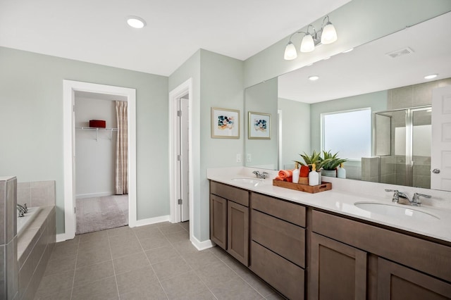 full bath featuring visible vents, a shower stall, a sink, and tile patterned flooring