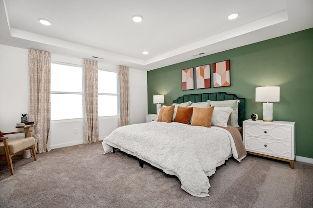 bedroom featuring carpet flooring, recessed lighting, baseboards, and a raised ceiling