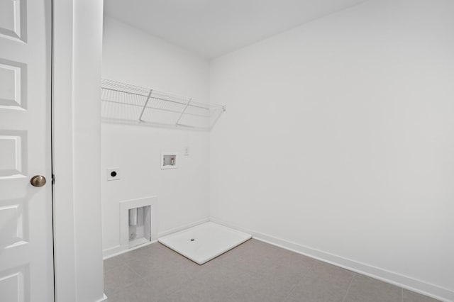 clothes washing area with hookup for an electric dryer, laundry area, baseboards, and hookup for a washing machine