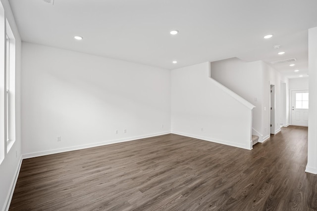 unfurnished room with dark wood-type flooring, recessed lighting, stairs, and baseboards