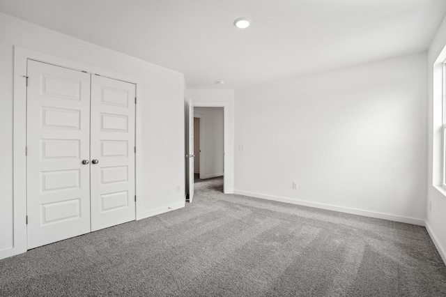 unfurnished bedroom featuring baseboards, carpet, a closet, and recessed lighting