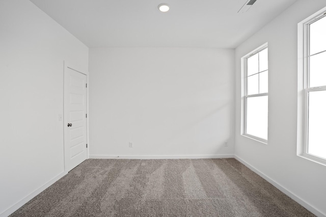 carpeted spare room featuring plenty of natural light, recessed lighting, and baseboards