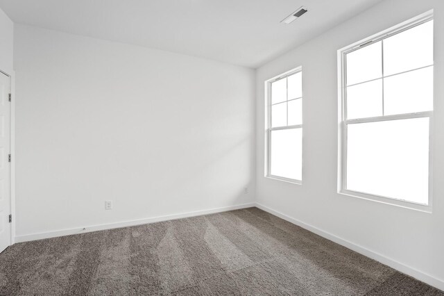 carpeted empty room with baseboards and visible vents