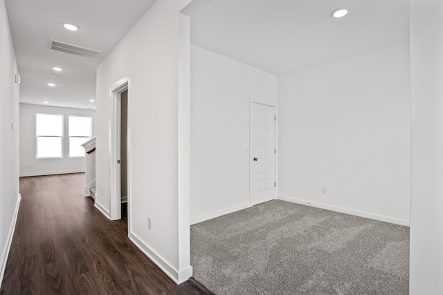 unfurnished room featuring visible vents, recessed lighting, baseboards, and dark wood-style flooring