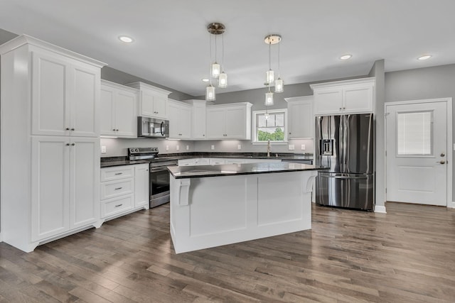 149 Watson Ct, Leoma, TN 38468 - kitchen featuring white cabinets, dark countertops, a sink, dark wood finished floors, and stainless steel appliances