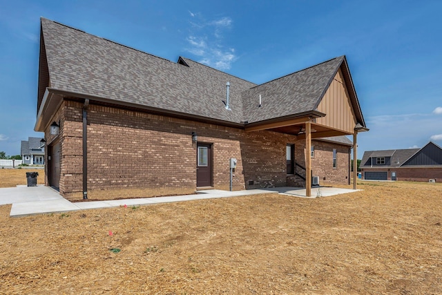 149 Watson Ct, Leoma, TN 38468 - rear view of house with brick siding, board and batten siding, roof with shingles, and a patio