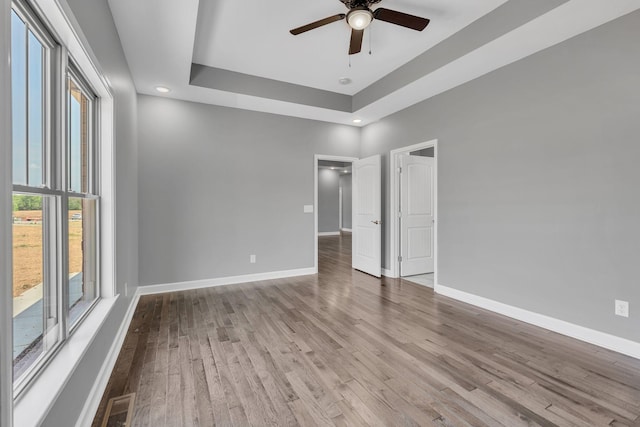 149 Watson Ct, Leoma, TN 38468 - spare room featuring baseboards, a ceiling fan, a raised ceiling, and wood finished floors
