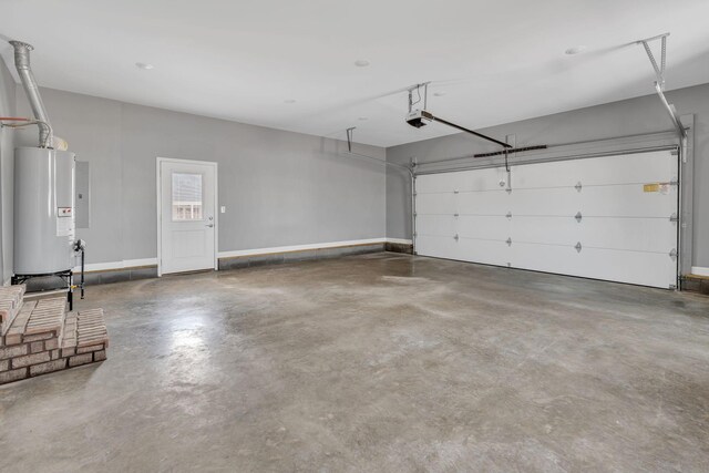 149 Watson Ct, Leoma, TN 38468 - garage with baseboards, a garage door opener, and gas water heater
