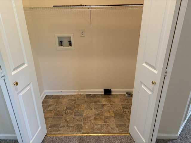 washroom with baseboards, laundry area, washer hookup, and stone finish flooring