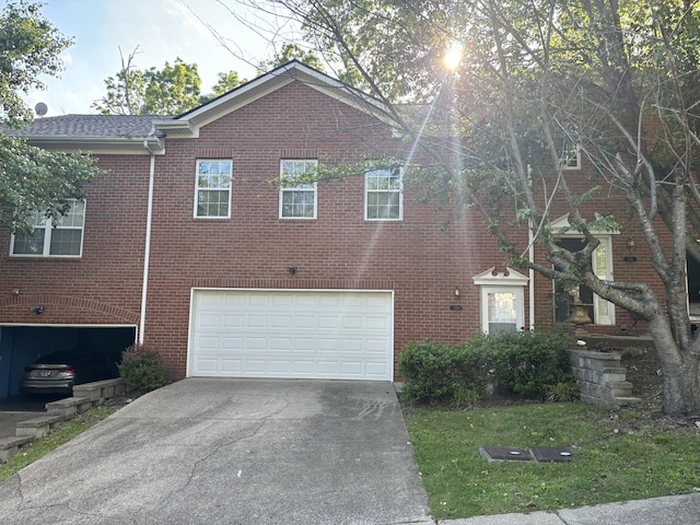 exterior space with brick siding, a garage, and concrete driveway
