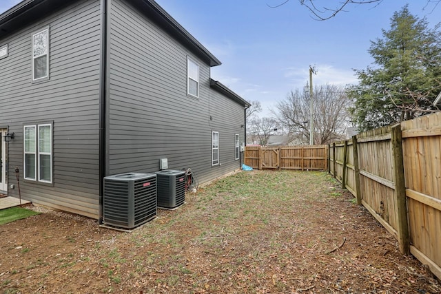 exterior space with cooling unit and a fenced backyard