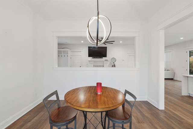 dining area with crown molding, baseboards, and wood finished floors