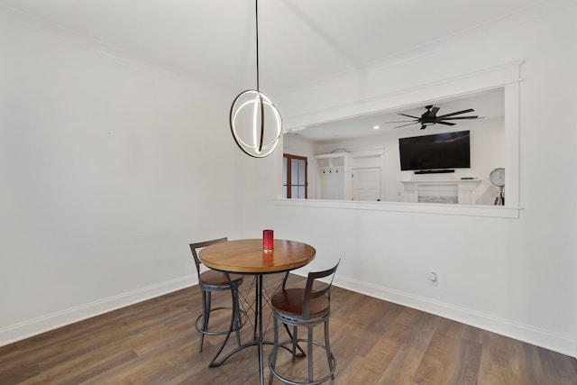 dining room with dark wood-style flooring, baseboards, and a ceiling fan
