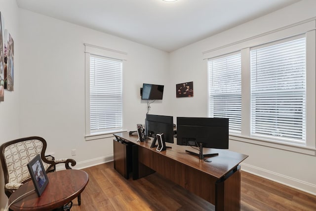 home office featuring a healthy amount of sunlight, baseboards, and wood finished floors