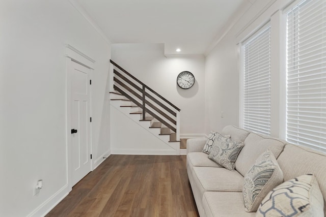 living room with crown molding, stairs, wood finished floors, baseboards, and recessed lighting