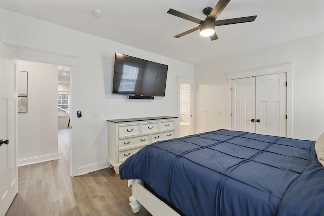 bedroom with baseboards, ceiling fan, and wood finished floors