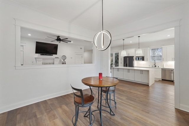 dining room featuring recessed lighting, a ceiling fan, baseboards, and wood finished floors