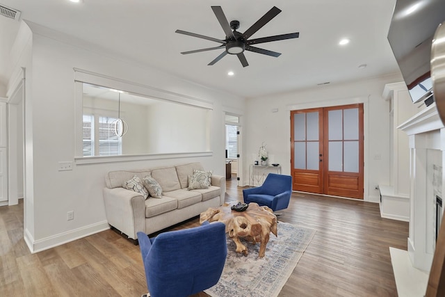 living area with recessed lighting, ceiling fan, visible vents, and wood finished floors