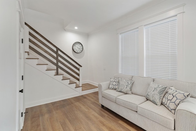 living room featuring recessed lighting, baseboards, wood finished floors, and stairway