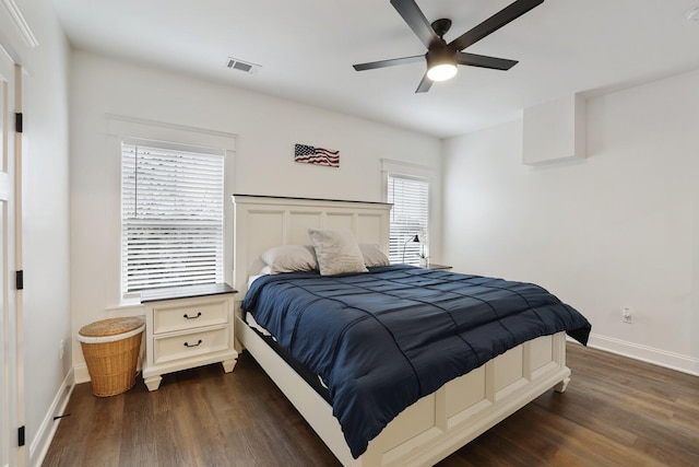 bedroom featuring baseboards, ceiling fan, dark wood-style floors, and visible vents