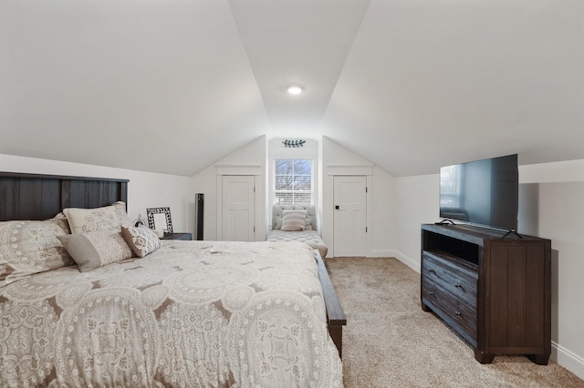 bedroom featuring baseboards, light carpet, and vaulted ceiling