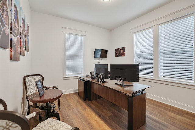 office area with baseboards and wood finished floors