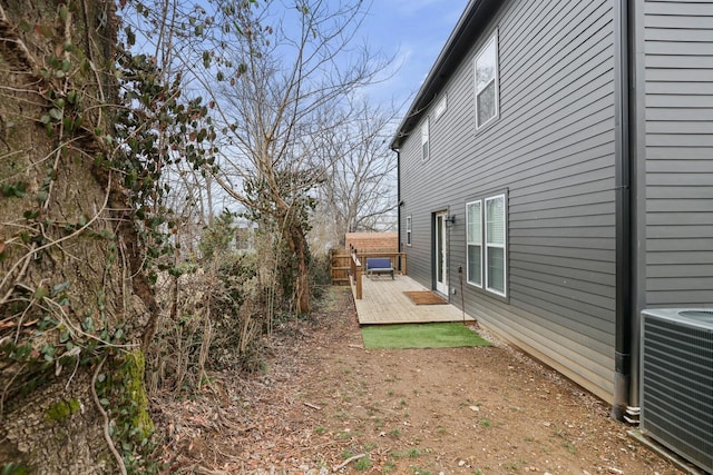 view of yard featuring a wooden deck and cooling unit