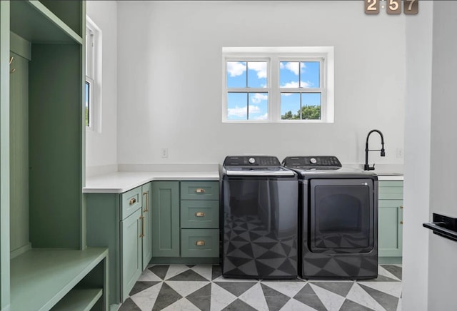 laundry area with a sink, cabinet space, and washer and dryer