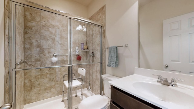 full bath featuring vanity, a shower stall, and toilet