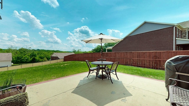 view of patio with outdoor dining area, a fenced backyard, and grilling area