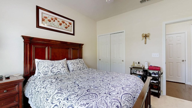 bedroom with light colored carpet and a closet