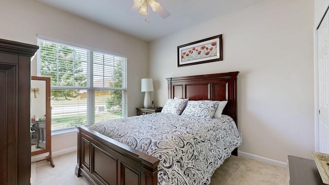 bedroom with baseboards, light carpet, and multiple windows
