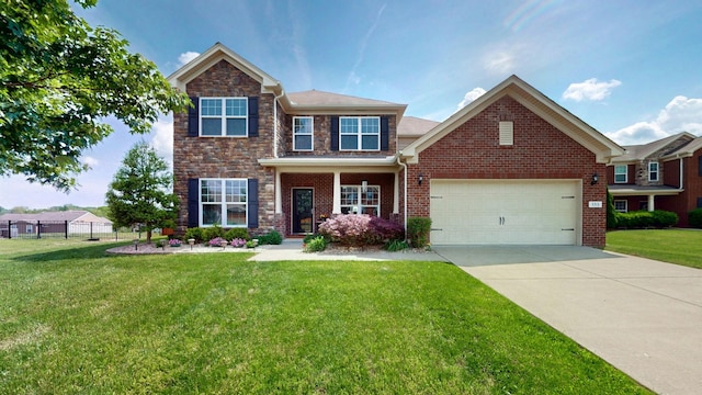 view of front facade with a front lawn, fence, brick siding, an attached garage, and driveway