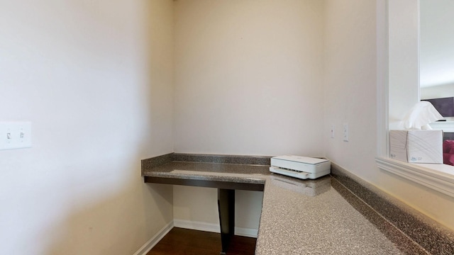 interior space with baseboards and built in study area
