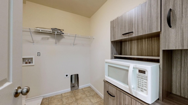 laundry area featuring laundry area, washer hookup, baseboards, and hookup for an electric dryer