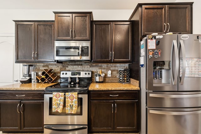141 Fieldcrest Cir, Hendersonville, TN 37075 - kitchen featuring appliances with stainless steel finishes, tasteful backsplash, and light stone counters