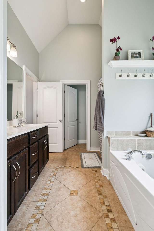 141 Fieldcrest Cir, Hendersonville, TN 37075 - bathroom featuring high vaulted ceiling, inlaid floor details, vanity, a garden tub, and baseboards