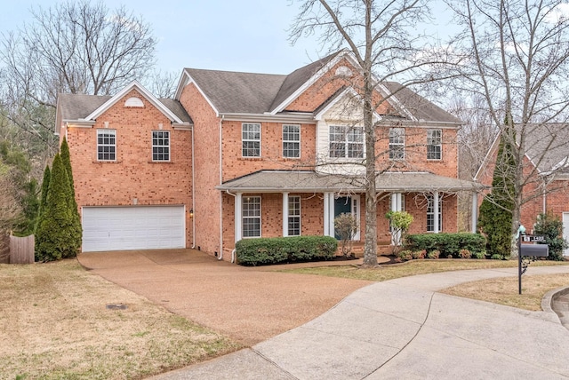 view of front facade with brick siding, a garage, a porch, and concrete driveway